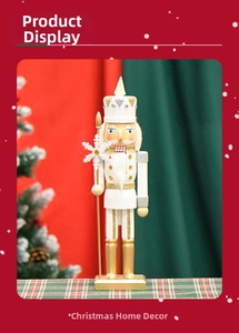Detail of white and champagne gold nutcracker featuring sparkly crown and snowflake staff