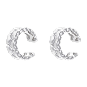 Close-up of silver-tone twisted ear cuffs with delicate heart pattern and polished finish