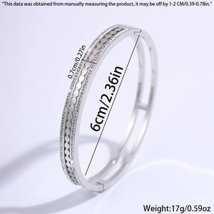 Detail showing gear design with small crystals on a silver titanium steel bangle