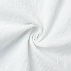 Macro shot of white cotton-linen fabric with textured pleats and soft woven structure