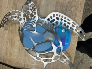 Detailed laser-cut turtle wall art showing intricate patterns and metallic texture