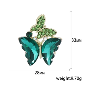 Elegant green crystal butterfly brooch in gold metal with dimensions 33mm and 28mm