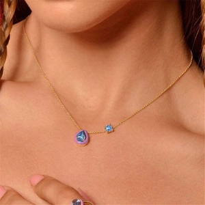 Detailed view of the S925 silver necklace with blue drop stone and purple enamel details