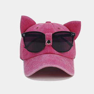 Detail view of pink baseball cap with cat ears and integrated pilot goggles decoration