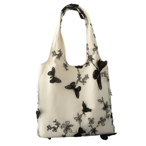 Minimalist white canvas tote bag with elegant black butterfly and floral lace embroidery