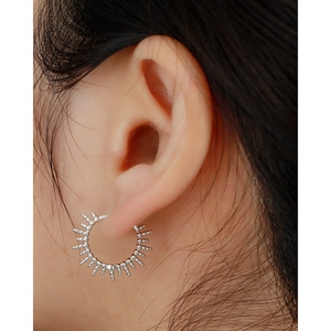 Close-up of S925 sterling silver geometric bead hoop earring worn on a model ear