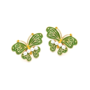 Detailed view of green enamel butterfly earrings with white pearls and gold plating