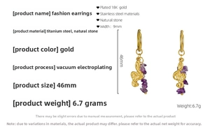 Macro detail of 18K gold plated music note earrings with purple natural crystal stones
