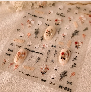 Detail of M-631 nail sticker showing retro red rose and bow designs on cream nails