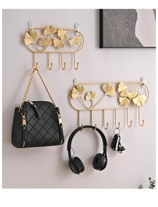 Detail of golden ginkgo leaf metal hooks showing round tips for safe item hanging