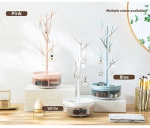 Macro detail of jewelry tree organizer with branches and storage base with drawer