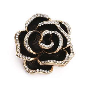 Detail shot of vintage black rose brooch with gold plating and sparkling crystal edges