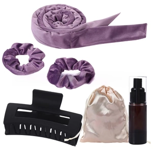 Detail view of purple velvet heatless hair curler set with claw clip and spray bottle