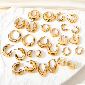 Close-up of assorted gold geometric hoop earrings with polished finish and textured designs