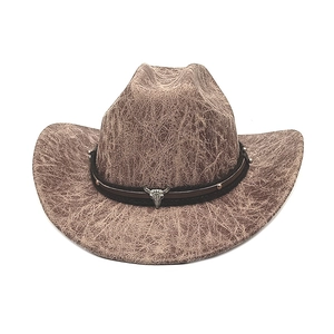 Detail of vintage western cowboy hat with leather band and metal bull skull ornament