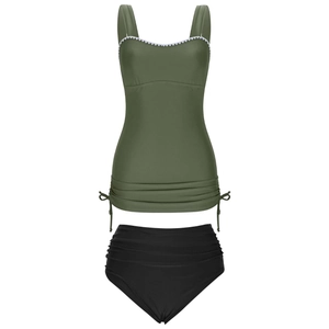 Detail of army green tankini top with white scalloped trim and black high waist bikini bottom