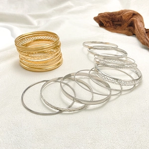 Detailed close-up of mixed gold and silver ethnic bangles with hammer textured finish