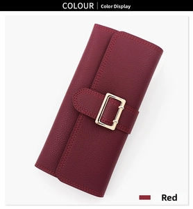 Detail of red pebbled leather long wallet with elegant gold rectangular metal clasp