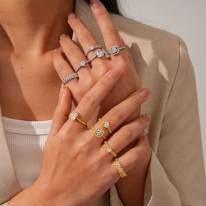 Detail of luxury stackable rings set with high-clarity zircon stones on model's hand