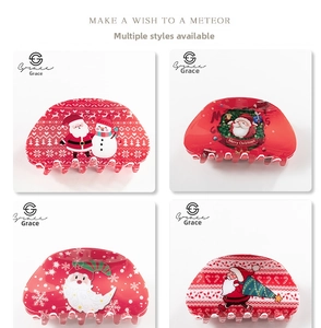 Detailed view of four festive Christmas hair claws featuring Santa and snowman patterns