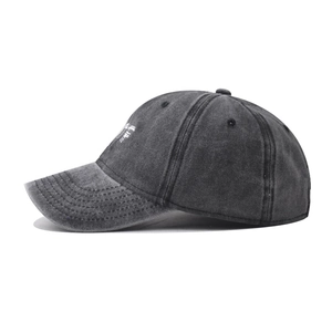 Detail of washed cotton baseball cap featuring vintage grey texture and white side embroidery