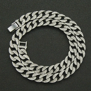 Silver iced out Cuban link chain necklace with sparkling rhinestones on black background