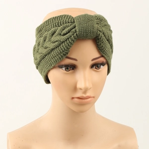 Close-up of green cable knit headband with center knot on mannequin head