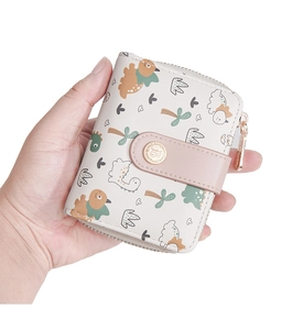 Detail of Baellerry short wallet with cute dinosaur print and pink metal snap closure