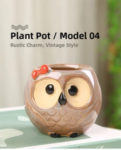 Detail of owl ceramic planter with red bow ornament on decorative books