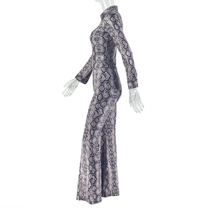 Detailed view of snake print pattern on high neck slim fit top and flared pants set