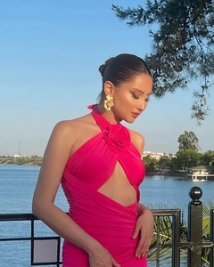 Detail of pink halter dress featuring 3D floral neck applique and waist cutout
