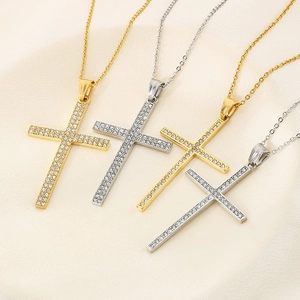Close-up of hip hop style iced out cross pendants in gold and silver steel finish