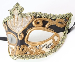 Detail of Venetian masquerade mask with music notes, gold glitter, and scrollwork patterns