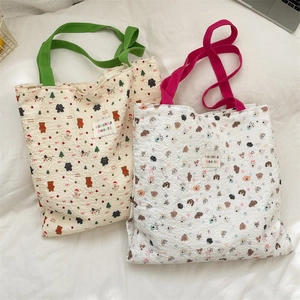 Detail of embossed bubble fabric tote bag featuring cute cartoon bear and pet patterns