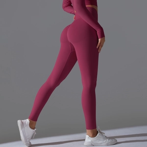 Macro detail of high-waist seamless yoga pants showing peach lift texture in burgundy