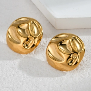 Detail of gold water ripple stud earrings with molten metal texture on a minimalist base