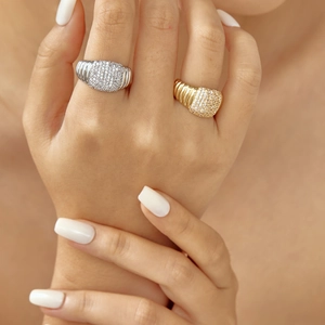 Macro shot of gold and silver copper rings with pavé cubic zirconia and textured band
