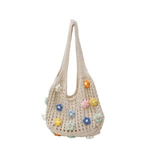 Beige hollow-out crochet tote bag with colorful 3D floral patterns for beach vacations