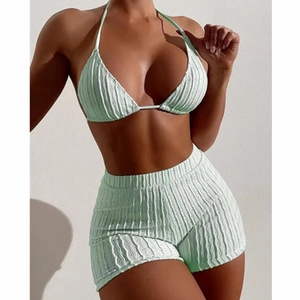 Two-piece mint green ribbed bikini set with halter top and high-waisted shorts
