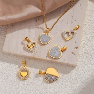Exquisite 18k gold plated heart pendants with rhinestones on a marble and silk background
