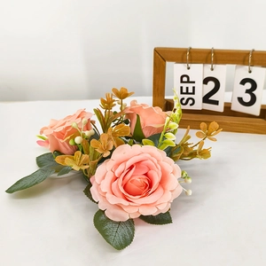 Macro detail of artificial pink rose wreath with silk flowers for romantic table decor