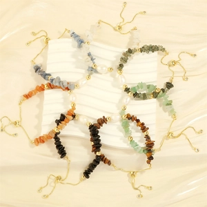 Detail of adjustable elastic bracelets with irregular colorful stones and freshwater pearls