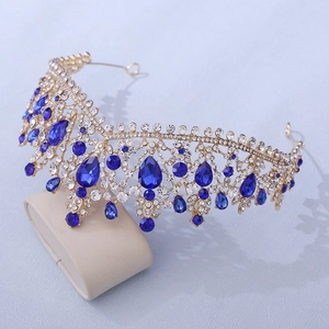 Macro detail of gold bridal tiara with blue teardrop rhinestones and clear crystals