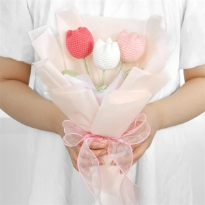 Handmade knitted tulip bouquet with red white and pink flowers in gift wrap