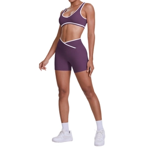 Two-piece purple yoga set with cross-waist shorts and white-edged cropped sports vest