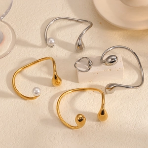 Minimalist geometric titanium steel bangle set with pearl drop ends in gold and silver