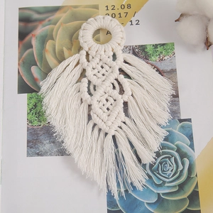 Handmade boho macrame wall hanging in white leaf shape crafted from cotton rope