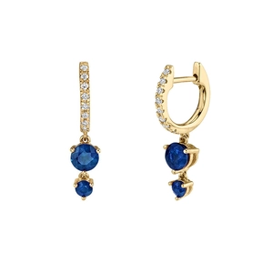Detailed macro view of gold-plated earrings with pavé stones and round blue zircons
