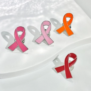 Enamel awareness ribbon brooches in pink, orange, and red on white steps display