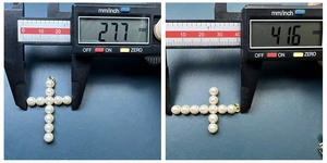 Detailed size measurement of gold pearl cross pendant showing 27.7mm by 41.6mm scale